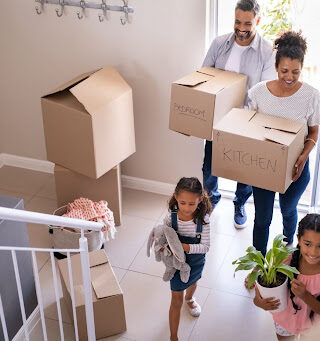 A family carrying boxes.