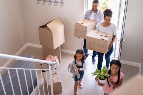 A family carrying boxes.