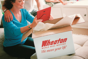 woman packing for a move with Wheaton moving boxes