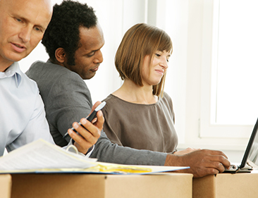 people talking amongst moving boxes