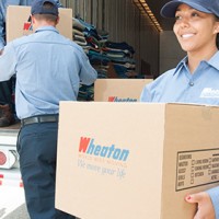 Wheaton's employee holding moving boxes