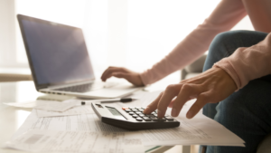 Woman on computer and calculator
