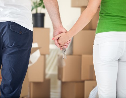 Holding Hands in front of boxes