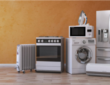 Set of household kitchen appliances on yellow background.