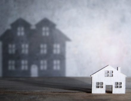 small model house casting a large shadow behind it. What Should I Get Rid Of When Downsizing?