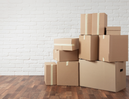 Stack of cardboard boxes in the empty room