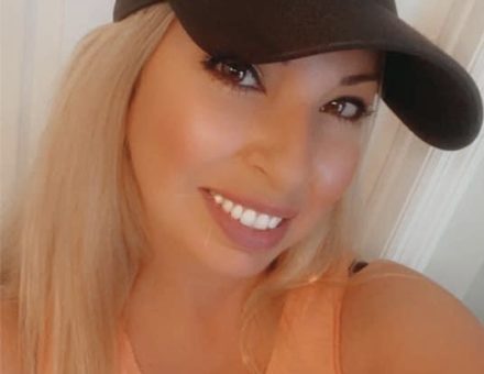 selfie of a woman in a black Underarmour hat