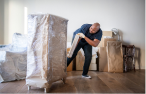 man rolling item on cart