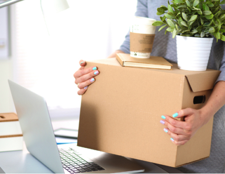 woman packing up belongings to move offices