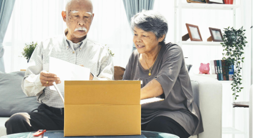 Senior citizen couple packing for a move