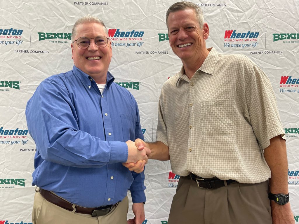 Incoming Wheaton vice president of operations, Kevin Miller, shakes hands with retiring Wheaton vice president of operations, Ron Borkowski.