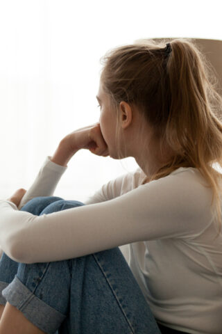 woman staring out a window.