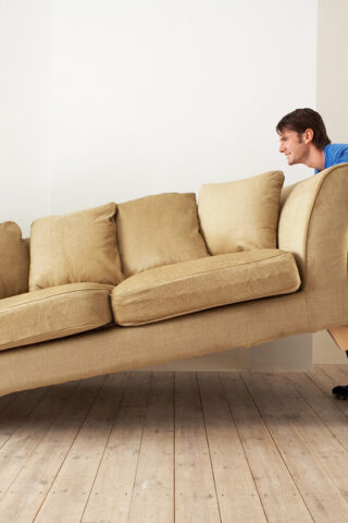 couple moving a couch.