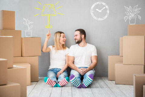 A couple surrounded by boxes.