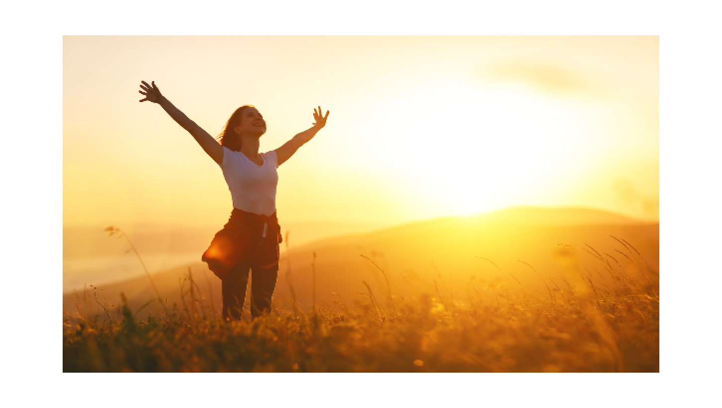 Happy woman jumping at sunrise