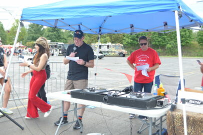 man with microphone at Wheaton Pulls for Good event