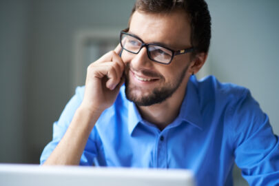 man wearing glasses talking on the cell phone