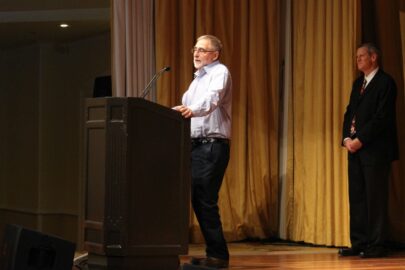 man giving a speech on stage