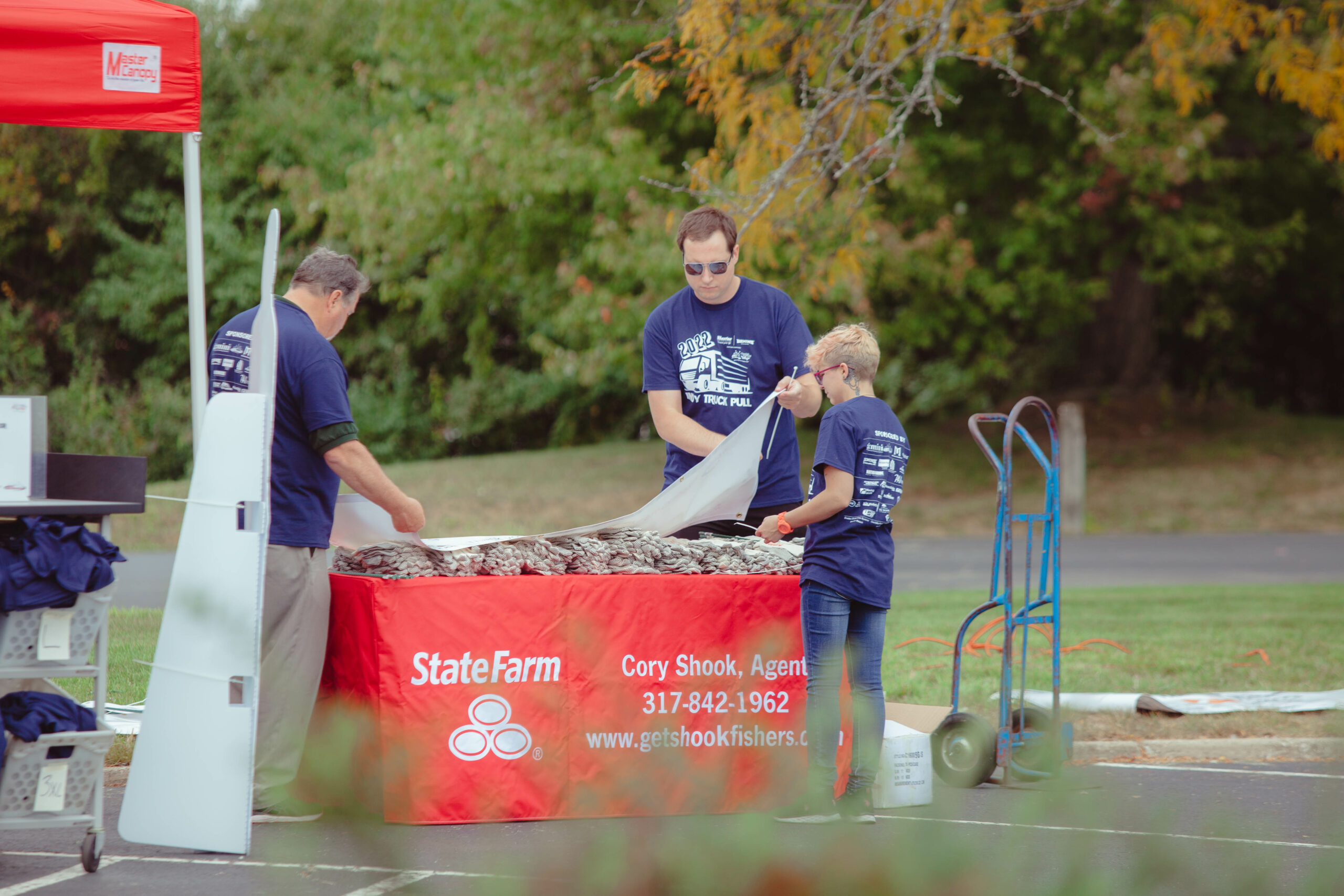 Wheaton staff and moving company volunteers set up sponsor table at Indy Truck Pull
