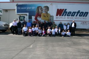 people posing in front of Wheaton's moving truck