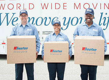 Wheaton employees holding moving boxes