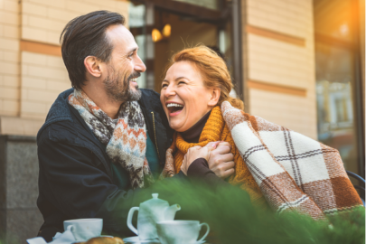 Middle aged couple laughing together at a cafe