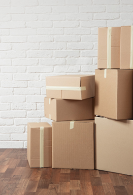 Stack of cardboard boxes in the empty room