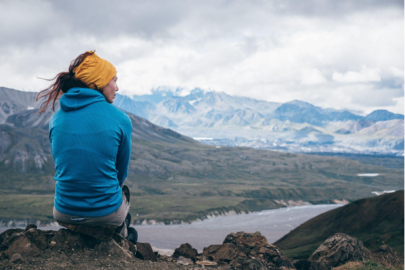 Woman sitting on a mountain