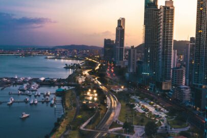 A city and its surrounding body of water at sunset.