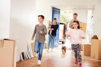 Kids running into new home with cardboard boxes