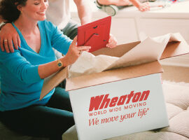 woman packing for a move with Wheaton moving boxes