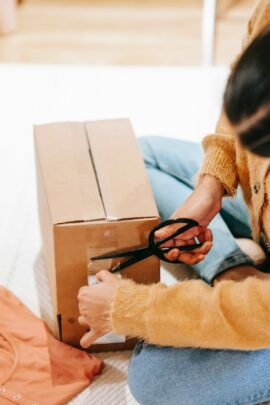 Person taping a box shut.