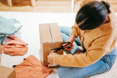 Person taping a box shut.