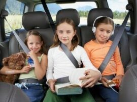 kids buckled in the backseat of a car