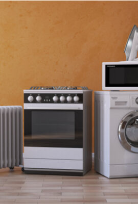 Set of household kitchen appliances on yellow background.