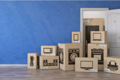 Cardboard boxes with images of electronics labeled on the outside