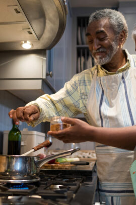 Smiling senior couple cook in the kitchen