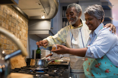 Smiling senior couple cook in the kitchen