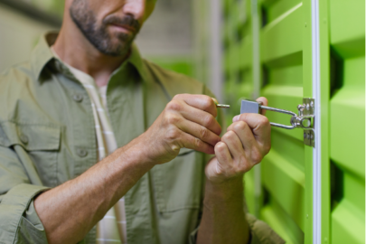 man inserting key into storage unit lock
