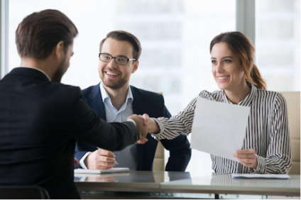 People shake hands in office.