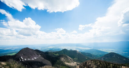 Mountains in front of a blue sky.