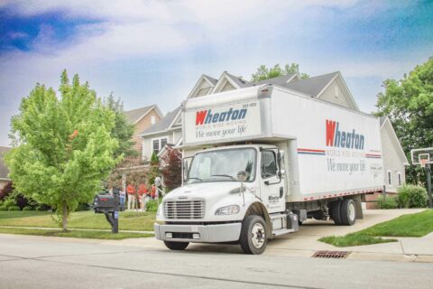 Wheaton moving truck in a driveway.