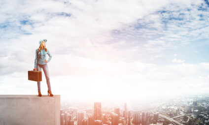 Person standing on a city building.