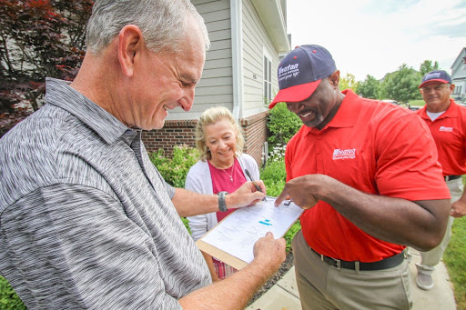 People smiling signing a contract.