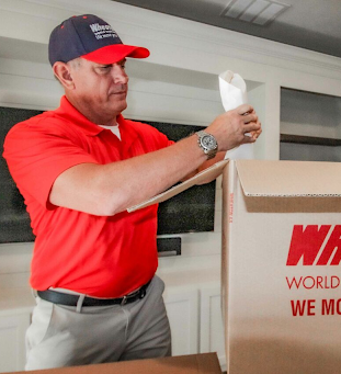 Man wrapping delicate items.