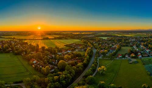 Sunset over a rural small town surrounded by farmland.